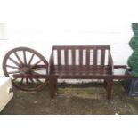 A two seat garden bench with cart wheel back,