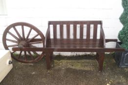 A two seat garden bench with cart wheel back,