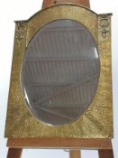 An Arts & Crafts polished brass arched top wall mirror, circa 1910,
