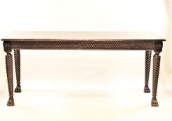 A Regency style mahogany serving table, the spirally reeded tapering legs on paw feet,
