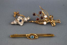 A collection of brooches to include a sapphire and diamond bar brooch - no hallmark - tests