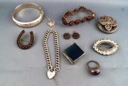 A collection of Jewellery to include a hallmarked silver bangle with leaf charm,