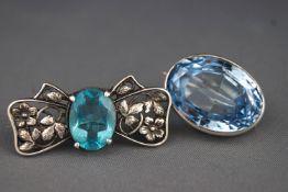 A stamped silver floral motif brooch set with blue paste stone