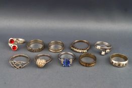 A selection of ten white metal rings of variable designs. Ranging is size from L to S.