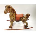 A 1950's tin rocking horse,