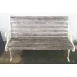 A Victorian style bench with white painted cast iron ends,