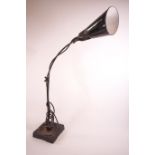 An adjustable desk lamp by Waligraph, with black and white enamel shape,