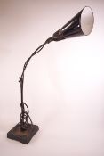 An adjustable desk lamp by Waligraph, with black and white enamel shape,