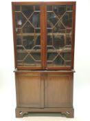 A 19th century mahogany standing corner cabinet, with two glazed doors above two panelled doors,