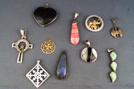 A collection of ten pendants of variable metals/designs.