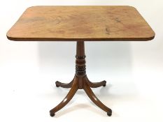 A William IV mahogany tilt top table on central turned stem and quadripartite base,