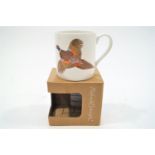 A boxed and signed Richard Bramble mug decorated with a pheasant in full flight,