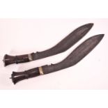 A pair of Kukri with hardwood handles,