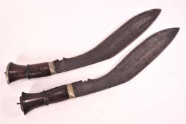 A pair of Kukri with hardwood handles,
