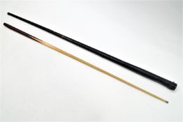 A mahogany and beechwood snooker cue in a black Japanned tube case, numbered 17,