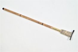 A heavy walking stick with faux ivory dog handle