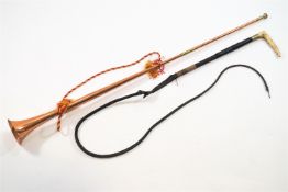 A copper hunting horn and a whip,