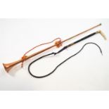 A copper hunting horn and a whip,