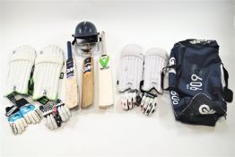 A cricket set, including three bats, three pairs of gloves, two sets of pads,