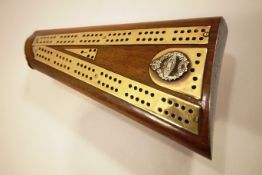 A trench art cribbage board, set on a gun stock with Tank Regiment crest, c 1920,