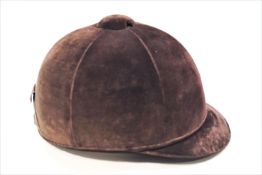 A brown velvet riding hat,