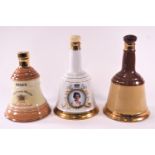 A collection of Wade stoneware Bells Whisky handbell shaped flagons (7), all empty,