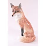 A Royal Worcester fox, seen in the seated position with his brush over his paws,