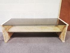 A smoked glass and marble coffee table,