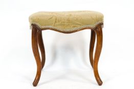 A Victorian rectangular stool, the upholstered seat on walnut cabriole legs,