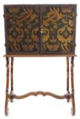 An early 20th century Continental embossed leather cabinet on stand