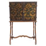 An early 20th century Continental embossed leather cabinet on stand