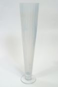 A large opalescent glass vase, of ribbed trumpet form, raised on a clear glass plain foot,