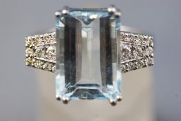 A white metal dress ring set with a rectangular cut aquamarine of approximately 6.25cts.