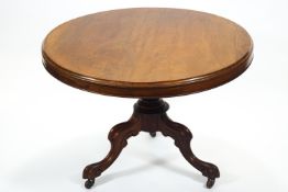 A mid 19th century mahogany round centre of breakfast table with plain top on a frieze