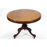 A mid 19th century mahogany round centre of breakfast table with plain top on a frieze