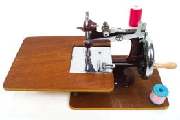 An Essex portable sewing machine in original case, with swing handle,