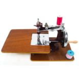 An Essex portable sewing machine in original case, with swing handle,