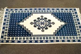 A Tunisian wool rug, in blue and white,