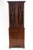 An Edwardian mahogany display cabinet with two glazed doors above one drawer and two panelled doors