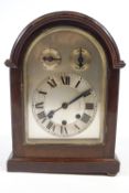 A mahogany cased mantel clock with brass handle, the silvered dial with slow/fast and chime/silent,