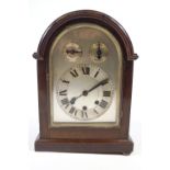 A mahogany cased mantel clock with brass handle, the silvered dial with slow/fast and chime/silent,