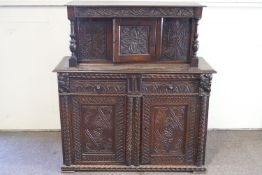 An 19th century oak court cupboard with central hinged door to the raised back,