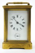 A carriage clock of usual five glass form with white enamel Roman dial and subsidiary Arabic alarm