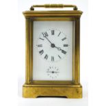 A carriage clock of usual five glass form with white enamel Roman dial and subsidiary Arabic alarm