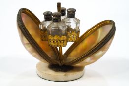 A perfume bottle holder in the form of mother of pearl gilt metal mounted opening to