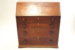 A George III mahogany bureau, the hinged fall front enclosing inlaid interior of pigeon holes,