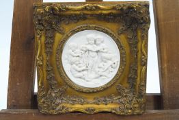 A gilt framed composition tondo of putti musicians,