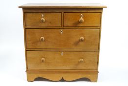 A Victorian pine chest of two short and two long drawers, on bracket feet with ivory escutcheons,