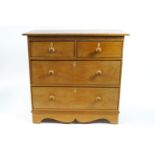 A Victorian pine chest of two short and two long drawers, on bracket feet with ivory escutcheons,