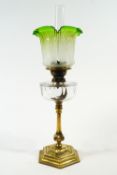 A Victorian glass and brass oil lamp, with the etched shade green tinted to the rim,